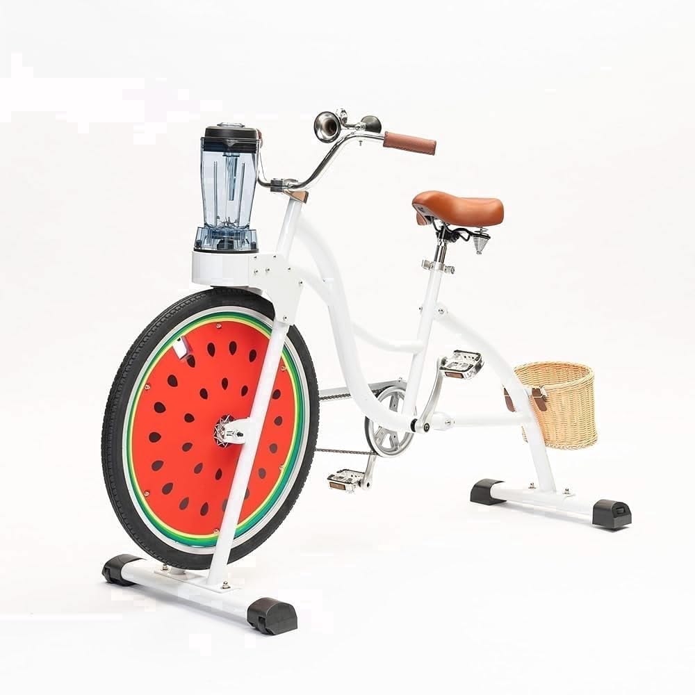 White smoothie bike with a watermelon wheel and pedal-powered blender